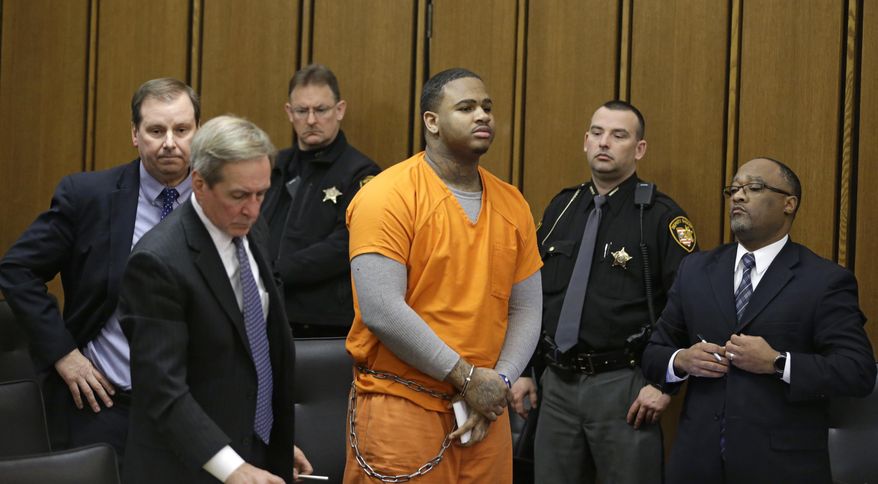 FILE - In this Monday, Dec. 19, 2016, file photo, Douglas Shine Jr., center, stands in the courtroom for sentencing in Cleveland. A decision by a Cleveland judge to overrule a jury’s death sentence recommendation for a triple killer highlights how rare such judicial decisions are. Judge Joan Synenberg cited defendant Shine’s childhood abuse as a child in sentencing him to life without parole on Dec. 19. (AP Photo/Tony Dejak, File)