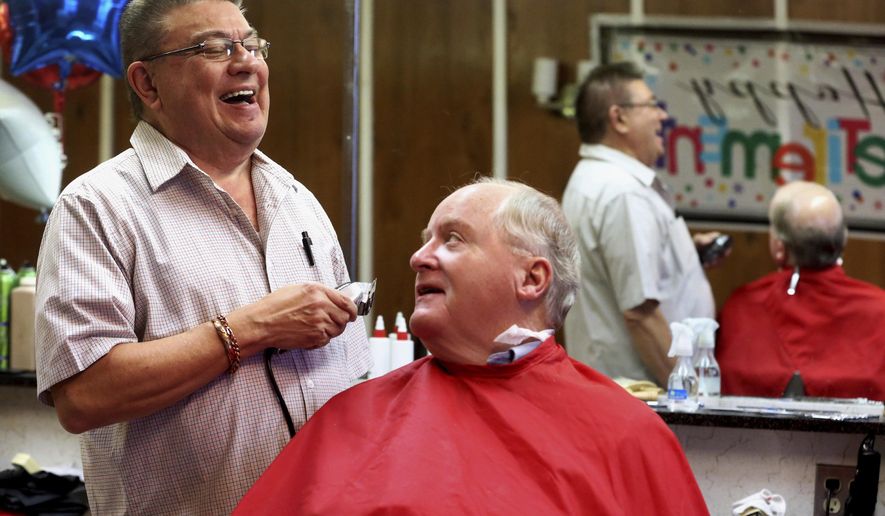 ADVANCE FOR WEEKEND EDITIONS - In this photo taken Wednesday, Dec. 21, 2016, Rick Klein gives a haircut to Jerry Koppes, of Dubuque, Iowa, at Link's Barber Shop in Dubuque. Klein is retiring after 53 years. (Jessica Reilly/Telegraph Herald via AP)