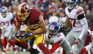Washington Redskins tight end Jordan Reed (86) breaks a tackle attempt by New York Giants cornerback Janoris Jenkins (20) during the first half of an NFL football game in Landover, Md., Sunday, Jan. 1, 2017. (AP Photo/Alex Brandon) **FILE**