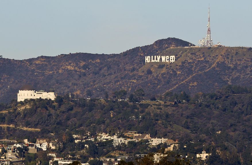 The Hollywood sign is seen vandalized Sunday, Jan. 1, 2017. Los Angeles residents awoke New Year's Day to find a prankster had altered the famed Hollywood sign to read "HOLLYWeeD." Police have notified the city's Department of General Services, whose officers patrol Griffith Park and the area of the rugged Hollywood Hills near the sign. California voters in November approved Proposition 64, which legalized the recreational use of marijuana, beginning in 2018. (AP Photo/Damian Dovarganes)