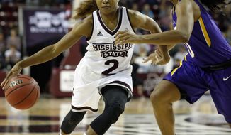 Mississippi State guard Morgan William (2) attempts to dribble past an LSU defender in the second half of an NCAA college basketball game in Starkville, Miss., Sunday, Jan. 1, 2017. (AP Photo/Rogelio V. Solis)