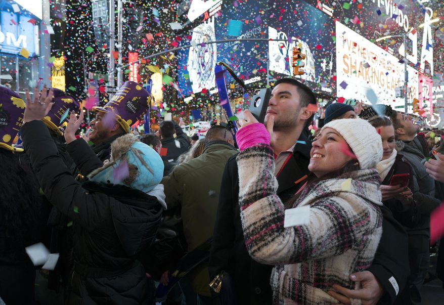 Confetti falls as people celebrate the new year in New York's Times Square, Sunday, Jan. 1, 2017. (AP Photo/Craig Ruttle)