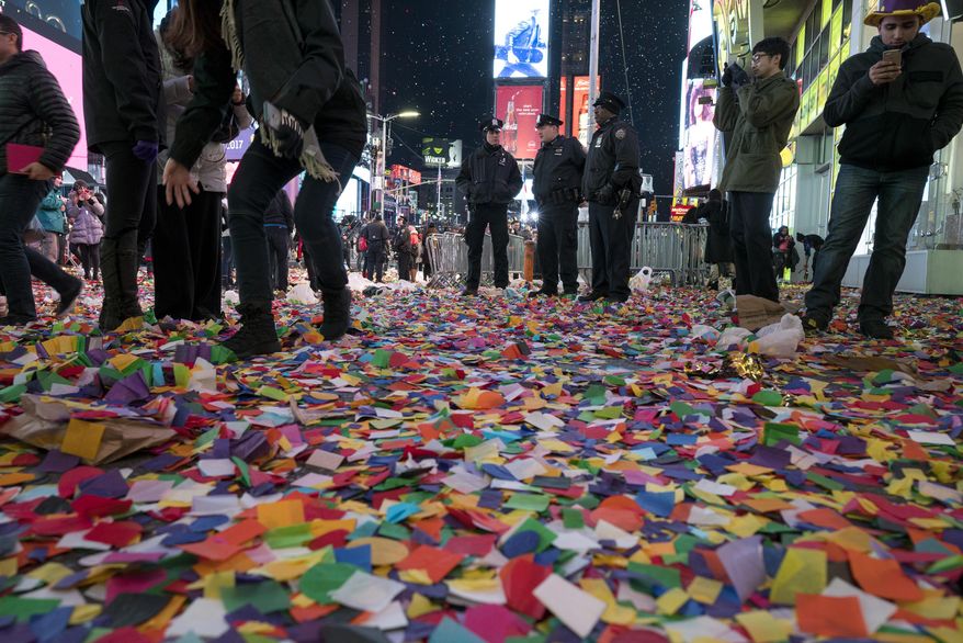 Confetti lies on the ground in New York's Times Square, Sunday, Jan. 1, 2017, as people celebrate the new year. (AP Photo/Craig Ruttle)