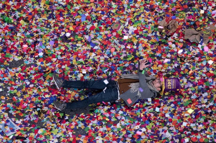 A reveler takes a selfie in the confetti during the new year celebration in New York's Times Square as seen from the Marriott Marquis, Sunday, Jan. 1, 2017. (AP Photo/Mary Altaffer)