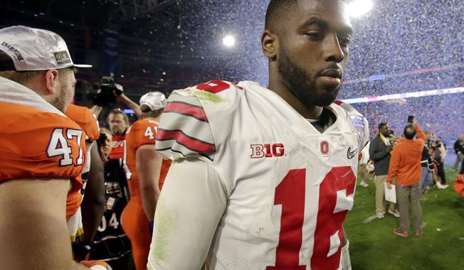 Ohio State quarterback J.T. Barrett leaves the field after the team's Fiesta Bowl NCAA college football playoff semifinal against Clemson, Saturday, Dec. 31, 2016, in Glendale, Ariz. Clemson won 31-0 to advance to the BCS championship game on Jan. 9 against Alabama. (AP Photo/Rick Scuteri)
