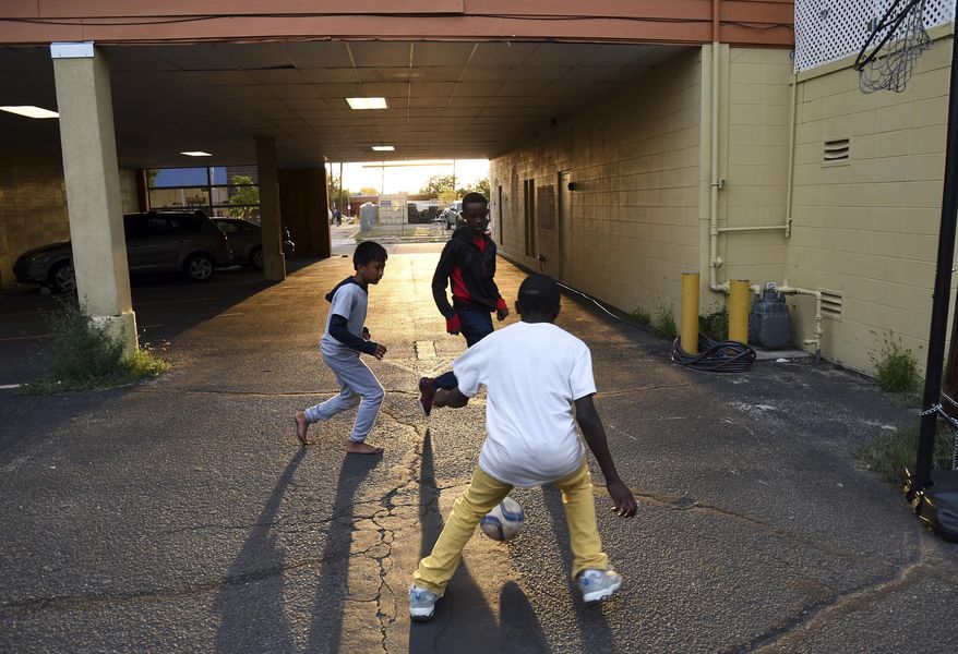 In this Sept. 9, 2016, photo, Boy Scouts play soccer at Mango House, a center for refugees in Aurora, Colo., before leaving on a troop camping trip to the mountains. Colorado Troop 1532, made up almost entirely of refugees, provides a blueprint for other Boy Scout groups to attract some of the thousands of refugees who may make the United States home in the coming years. (AP Photo/Thomas Peipert)
