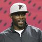 Former Atlanta Falcons quarterback Michael Vick sports a team hat as he returns to the Georgia Dome before the Falcons played the New Orleans Saints in an NFL football game Sunday, Jan. 1, 2017, in Atlanta. (Curtis Compton/Atlanta Journal-Constitution via AP)