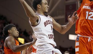 Boston College guard Jerome Robinson (1) looks to pass under the basket as Syracuse forward Taurean Thompson (12) defends during the second half of an NCAA college basketball game in Boston, Sunday, Jan. 1, 2017. (AP Photo/Mary Schwalm)