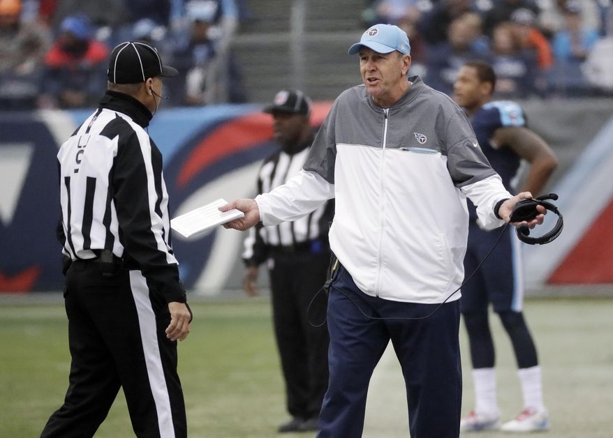 Tennessee Titans head coach Mike Mularkey argues a call with line judge Mark Perlman in the first half of an NFL football game Sunday, Jan. 1, 2017, in Nashville, Tenn. (AP Photo/James Kenney)