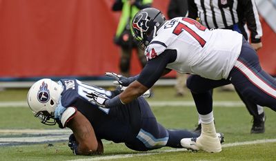 Tennessee Titans defensive lineman DaQuan Jones, left, recovers a Houston Texans fumble in the end zone for a touchdown ahead of Houston Texans tackle Chris Clark (74) in the first half of an NFL football game Sunday, Jan. 1, 2017, in Nashville, Tenn. (AP Photo/Mark Zaleski)