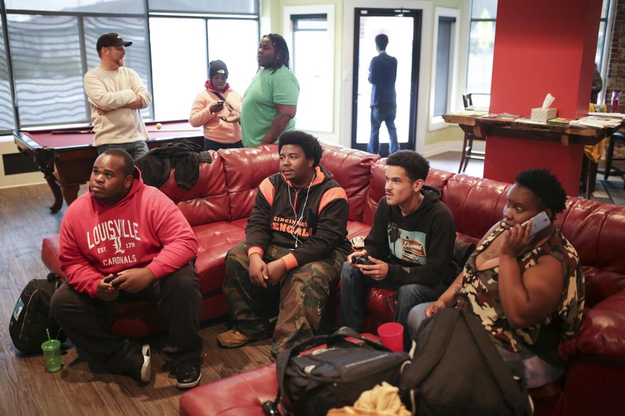 In this Dec. 5, 2016 photo, Members of TAYLRD spend some down time playing video games in the commons area at the facility, in Louisville, Ky. TAYLRD opened in Dec. of 2015 and is a drop-in center for youth ages 16 to 25 who struggle with some type of mental or behavioral health issue, from anxiety to bipolar disorder to schizophrenia. Many of these youth are also homeless. Supported by a federal grant, TAYLRD serves dozens of clients at no cost. (Alton Strupp/The Courier-Journal via AP)