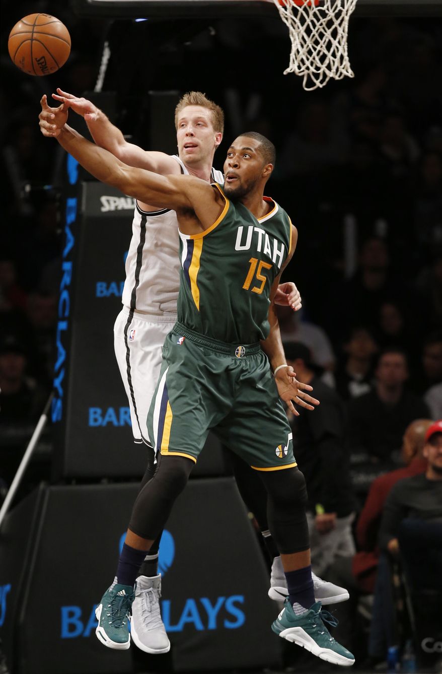 Brooklyn Nets' center Justin Hamilton tips the ball from Utah Jazz forward Derrick Favors (15) in the first half of an NBA basketball game, Monday, Jan. 2, 2017, in New York. (AP Photo/Kathy Willens)