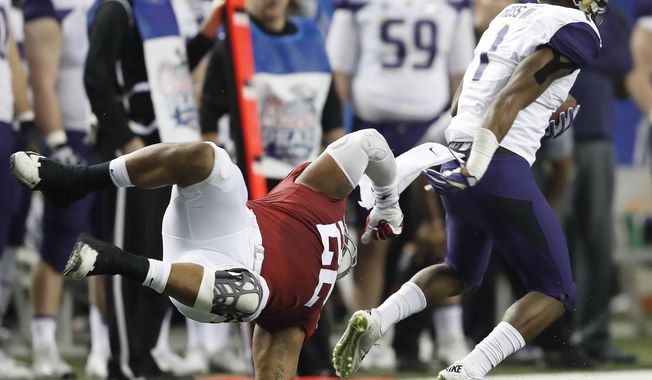 Washington wide receiver John Ross (1) runs past Alabama linebacker Ryan Anderson (22) during the first half of the Peach Bowl NCAA college football playoff game, Saturday, Dec. 31, 2016, in Atlanta. (AP Photo/John Bazemore)