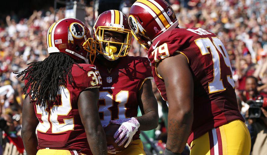 Robert Kelley, left, Matt Jones, center, and Ty Nsekhe celebrate Jones&#39; touchdown in October. Kelley eventually replaced Jones as the Redskins&#39; lead back and could handle the position next season, too. / AP photo