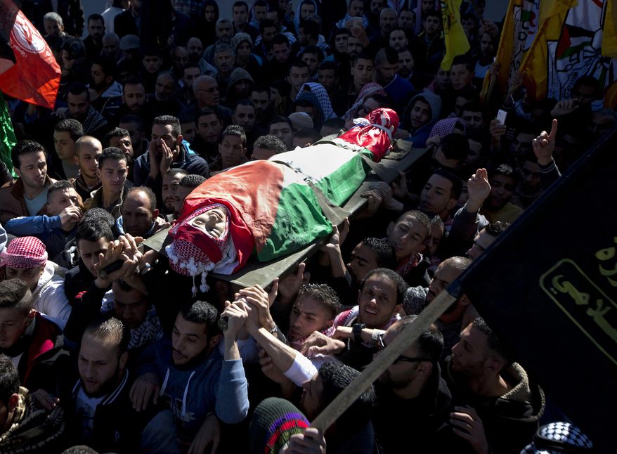 File - In this Tuesday, Dec. 8, 2015 file photo, Palestinian mourners carry the body of Malik Shaheen, 21, who was killed in clashes with Israeli troops, during his funeral in Deheishe refugee camp near the West Bank city of Bethlehem. Israeli advocacy group Yesh Din is criticizing what it says is an "exceptionally low" prosecution rate by the Israeli military in cases of violence committed by soldiers against Palestinians. Yesh Din says the army opened 186 criminal investigations into suspected offenses against Palestinians in 2015, but just four of those investigations yielded indictments. (AP Photo/Majdi Mohammed, File)