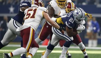 FILE - In this Nov. 24, 2016 file photo, Dallas Cowboys running back Ezekiel Elliott (21) struggles for extra yardage as Washington Redskins&#39; Will Compton (51) and Donte Whitner Sr., rear, make the stop in the first half of an NFL football game, in Arlington, Texas. More than just struggling against the run and pass, Washington was worst in the league in third-down defense and among the worst teams in the red zone. Whether that’s scheme or personnel is a matter of debate but most likely a combination of the two. (AP Photo/Ron Jenkins, File)