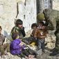 This undated handout photo released by the Russian Defense Ministry claims to show a Russian Military engineer distributing juice to local children in Aleppo, Syria.(Russian Defense Ministry Press Service photo via AP)