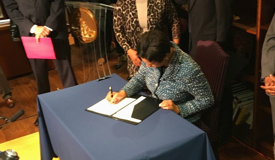 D.C. Mayor Muriel Bowser signed  into a law a measure that closes a loophole that had allowed criminals to tamper with their GPS monitoring devices without facing additional punishment. (Ryan M. McDermott/The Washington Times)