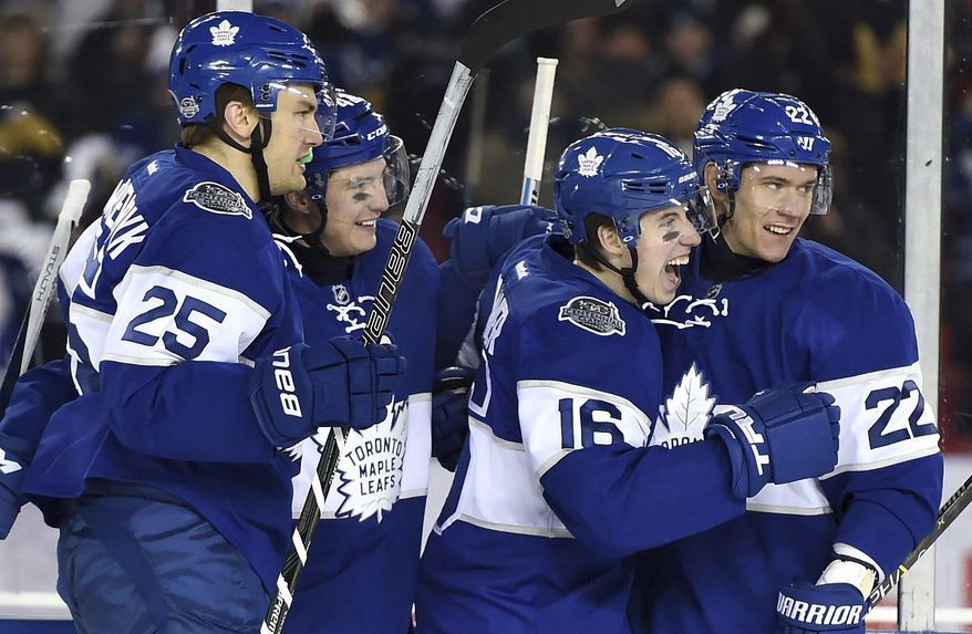 FILE - In this Jan. 1, 2017 file photo, Toronto Maple Leafs center Mitch Marner (16) celebrates his goal with teammates James van Riemsdyk (25), Tyler Bozak (42) and Nikita Zaitsev (22) during the third period of the NHL Centennial Classic hockey game in Toronto. The franchise is celebrating its 100th year while also trying to move past half a century without a championship. And what better way to do so than to bring back the old guard, including members of the 1967 team, the last Maple Leafs squad to win a Stanley Cup. George Armstrong, Dave Keon, Johnny Bower - meet Marner, Auston Matthews, William Nylander and company. (Frank Gunn/The Canadian Press via AP, File)