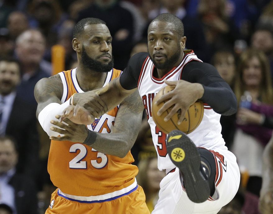 Cleveland Cavaliers' LeBron James, left, fouls Chicago Bulls' Dwyane Wade in the second half of an NBA basketball game, Wednesday, Jan. 4, 2017, in Cleveland. The Bulls won 106-94. (AP Photo/Tony Dejak)
