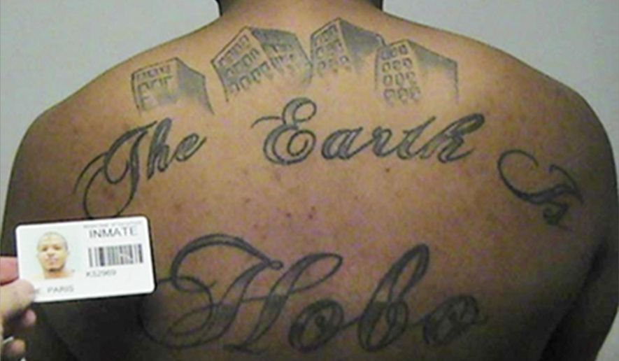 FILE - This undated file photo in a court filing provided by the United States Attorney's office in Chicago, shows Paris Poe's back tattoo that reads "The Earth Is Our Turf", and Hobo. Poe is one of six defendants on trial for racketeering and other charges are purported leaders of the widely feared Hobos, a South Side gang that federal prosecutors said murdered, maimed and tortured their way into control of some of Chicago's most lucrative drug markets. (United States Attorney's office in Chicago via AP file)