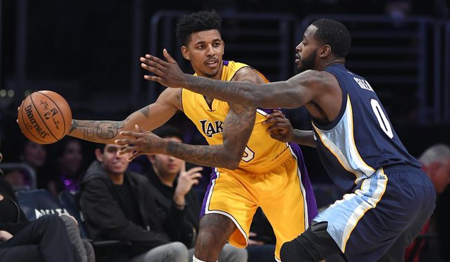 Los Angeles Lakers guard Nick Young, left, tries to pass the ball while under pressure from Memphis Grizzlies forward JaMychal Green during the first half of an NBA basketball game, Tuesday, Jan. 3, 2017, in Los Angeles. (AP Photo/Mark J. Terrill)