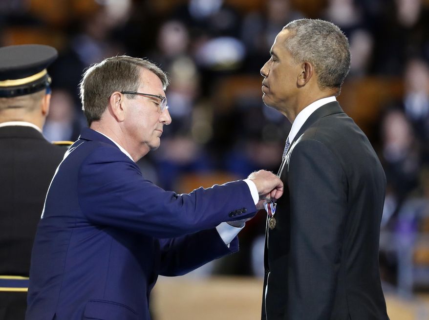 Defense Secretary Ash Carter pins the Department of Defense for Distinguished Public Service on President Barack Obama during an Armed Forces Full Honor Farewell Review for the president, Wednesday, Jan. 4, 2017, at Conmy Hall, Joint Base Myer-Henderson Hall, Va. (AP Photo/Alex Brandon)