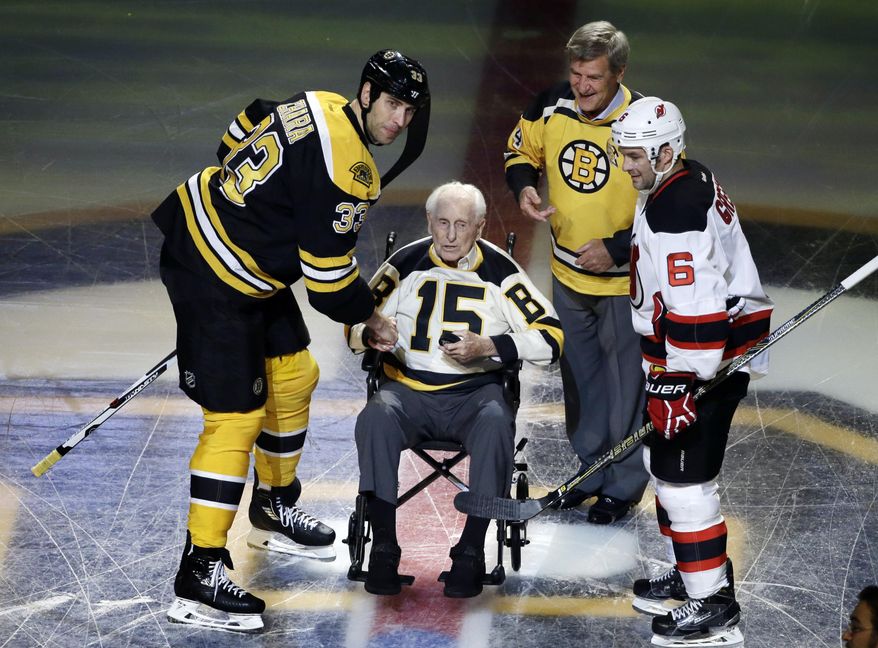FILE - In this Oct. 20, 2016, file photo, Boston Bruins defenseman Zdeno Chara (33) and New Jersey Devils defenseman Andy Greene (6) participate with Bruins legends Milt Schmidt (15) and Bobby Orr in a ceremonial puck drop before an NHL hockey game in Boston. Schmidt, a hockey hall of famer, has died at the age of 98, Bruins team spokesman Matt Chmura said Wednesday, Jan. 4, 2017. Schmidt, the NHL MVP in 1951, was the league's oldest living former player. (AP Photo/Elise Amendola, File)