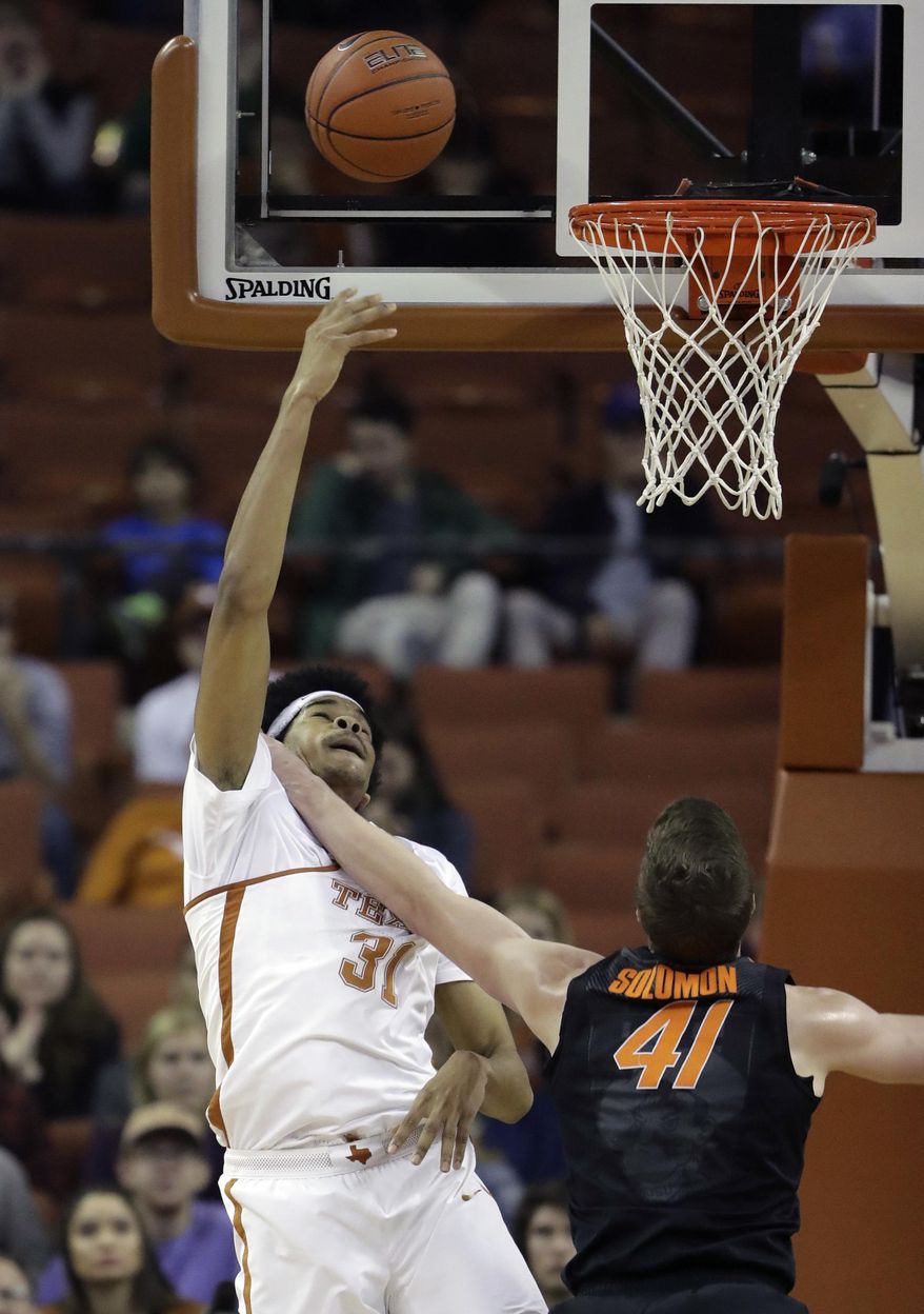 Texas forward Jarrett Allen (31) is fouled by Oklahoma State forward Mitchell Solomon (41) as he shoots during the first half of an NCAA college basketball game, Wednesday, Jan. 4, 2017, in Austin, Texas. (AP Photo/Eric Gay)