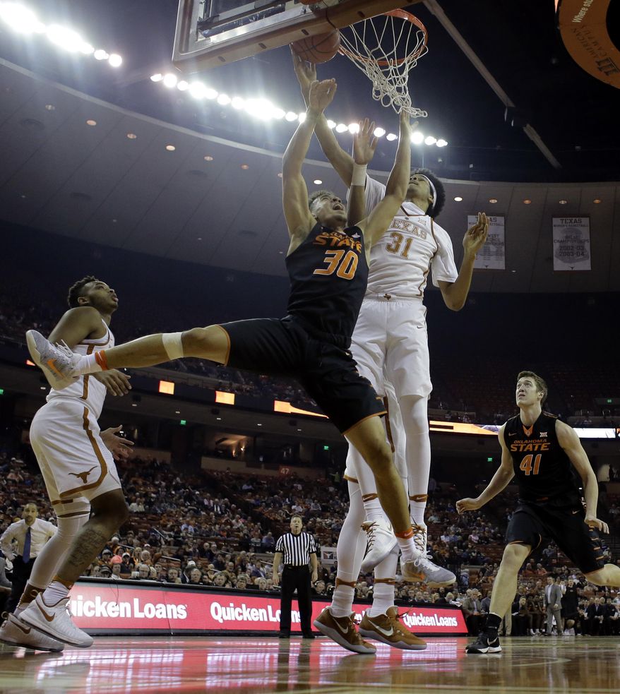 Oklahoma State guard Jeffrey Carroll (30) is blocked by Texas forward Jarrett Allen (31) as he tires to score during the first half of an NCAA college basketball game, Wednesday, Jan. 4, 2017, in Austin, Texas. (AP Photo/Eric Gay)