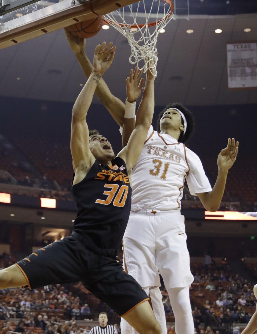 Oklahoma State guard Jeffrey Carroll (30) is blocked by Texas forward Jarrett Allen (31) as he tries to score during the first half of an NCAA college basketball game, Wednesday, Jan. 4, 2017, in Austin, Texas. (AP Photo/Eric Gay)