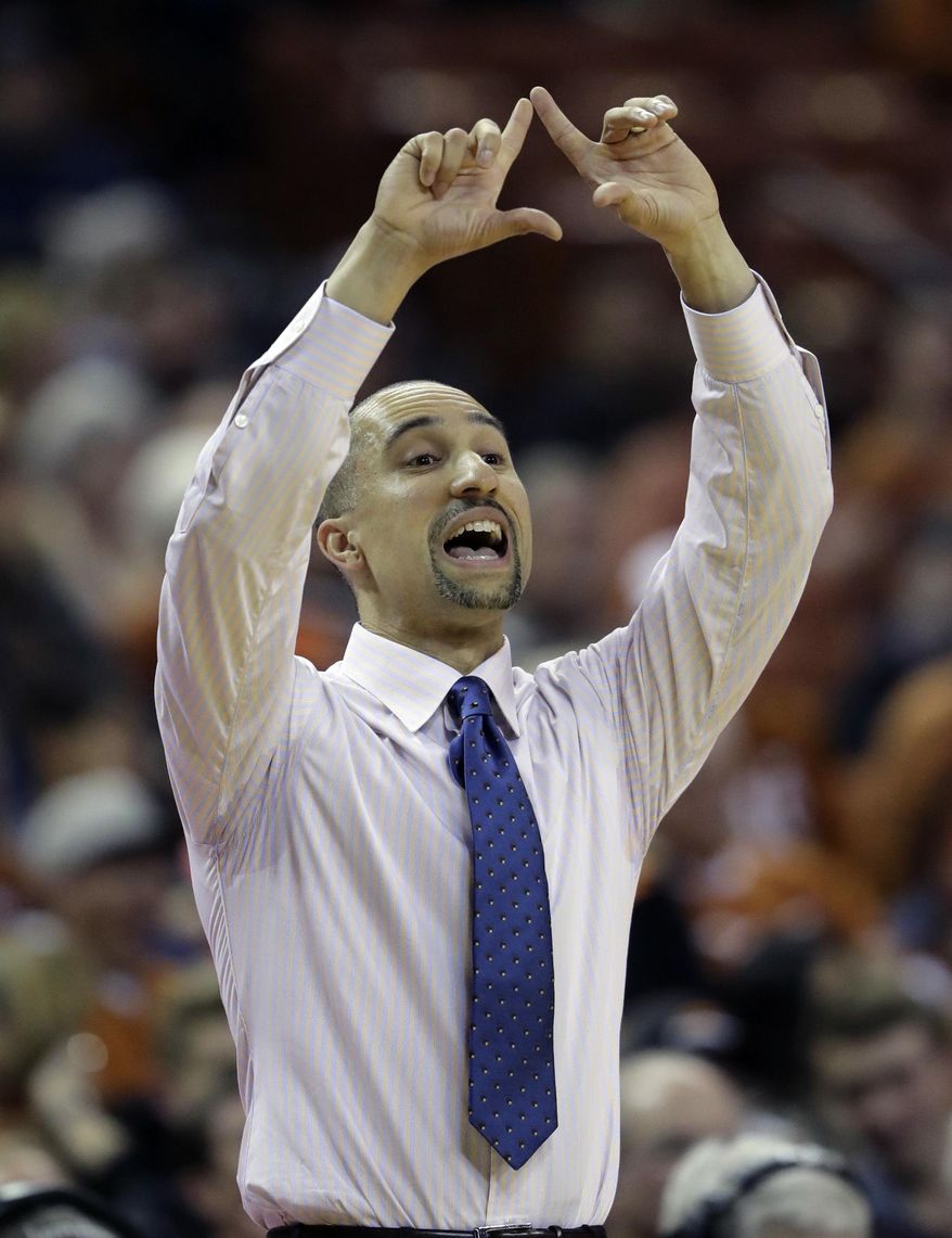 Texas head coach Shaka Smart signals to his players during the first half of an NCAA college basketball game against Oklahoma State, Wednesday, Jan. 4, 2017, in Austin, Texas. (AP Photo/Eric Gay)