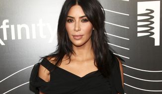 FILE - In this May 16, 2016 file photo, Kim Kardashian West attends the 20th Annual Webby Awards in New York. Kardashian West returned to social media on Tuesday, Jan. 3, 2017, three months after going silent in the wake of being held up and robbed of millions in jewelry at a Paris hotel.  (Photo by Andy Kropa/Invision/AP, File)