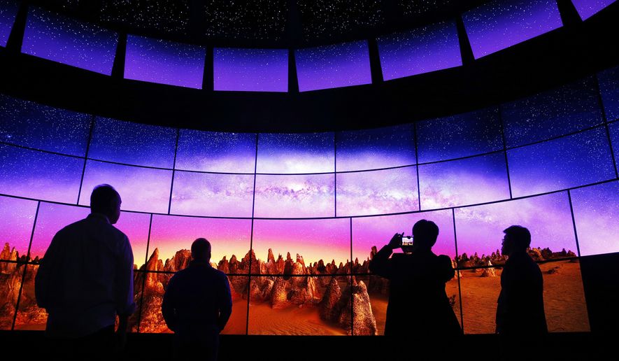 FILE - In this Thursday, Jan. 7, 2016, file photo, people look at an LG OLED 4K TV display at the LG booth during CES International, in Las Vegas. Flashy new television sets with buzzwords such as 4K, quantum dot and OLED are appearing at the annual CES gadget show in Las Vegas during the first week of 2017. Expect bigger sizes and brighter, more colorful pictures. This year is mostly about improving what’s already out there. (AP Photo/John Locher, File)
