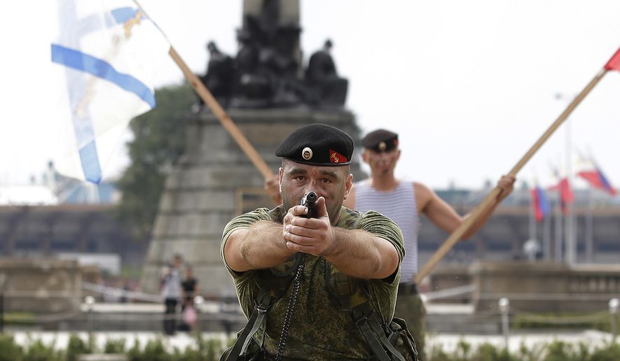 A Russian Marine aims his pistol during a Capability Demonstration at Manila&#x27;s Rizal Park, Philippines on Thursday, Jan. 5, 2017. Russia is eyeing naval exercises with the Philippines and deployed two navy ships for a goodwill visit to Manila as Moscow moves to expand defense ties with the country. (AP Photo/Aaron Favila)