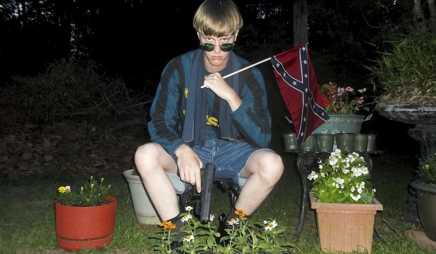 FILE - This undated photo that appeared on Lastrhodesian.com, a website investigated by the FBI in connection with Dylann Roof, shows him posing for a photo holding a Confederate flag. During Dylan Roof's sentencing for friends and family members walked up to the witness stand and testified about the nine black church members gunned down during a Bible study. The testimony came during the sentencing phase of Dylann Roof's death penalty trial. (Lastrhodesian.com via AP, File)