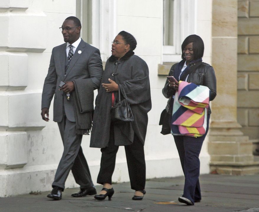 The Rev. Kylon Middleton, from left, Jennifer Pinckney, widow of Emanuel's slain pastor, the Rev. Clementa Pinckney and Johnette Martinez enter the courthouse in Charleston, S.C., Wednesday, Jan. 4, 2017, for the sentencing phase of Dylann Roof's trial. The jury last month unanimously found Roof guilty of hate crimes and other charges in the shooting deaths of nine black church members during Bible study. The jurors will now decide whether he should be sentenced to life in prison or death. (Leroy Burnell/The Post And Courier via AP)