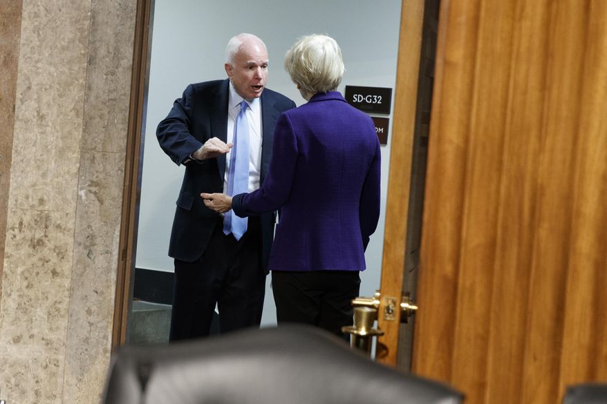 Senate Armed Services Committee Chairman Sen. John McCain, R-Ariz., left, talks with Sen. Elizabeth Warren, D-Mass. on Capitol Hill in Washington, Thursday, Jan. 5, 2017, prior to the start of the committee's hearing: "Foreign Cyber Threats to the United States." (AP Photo/Evan Vucci)