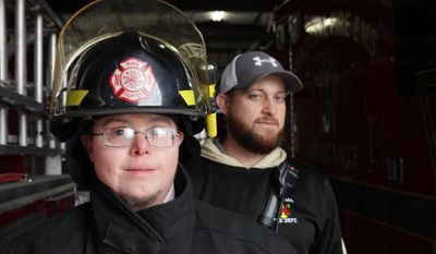 ADVANCE FOR USE SUNDAY, JAN. 8, 2017 AND THEREAFTER - In this Dec. 15,  2016 photo, Sandoval firefighter Jason Eagan, left, poses for a photo with Lt. Matt Horn at the firehouse in Sandoval, Ill. Jason, who is 33, has Down syndrome. There was concern in the department about Jason joining the force but he passed the firefighters&#39; physical, paperwork was filled out, and it became official: Jason was a firefighter. He serves under cadet guidelines, and doesn&#39;t go into burning buildings or or engage in perilous rescues. But he is a firefighter. ( Brian Brueggemann/Belleville News-Democrat, via AP)
