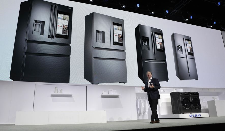 John Herrington, senior vice president of Samsung Electronics America, unveils new refrigerators with Family Hub 2.0 during a Samsung news conference before CES International, Wednesday, Jan. 4, 2017, in Las Vegas. Family Hub 2.0 features an interface on the refrigerator with apps that can be controlled by voice recognition. (AP Photo/John Locher)
