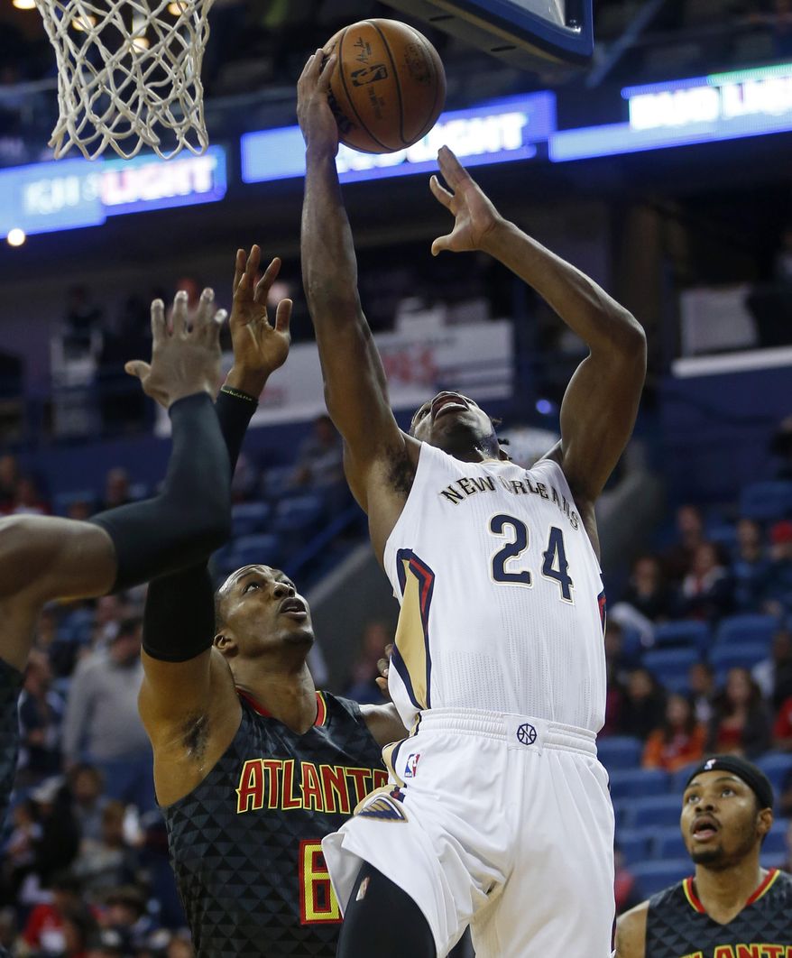 New Orleans Pelicans guard Buddy Hield (24) drives to the basket against Atlanta Hawks center Dwight Howard (8) in the first half of an NBA basketball game in New Orleans, Thursday, Jan. 5, 2017. (AP Photo/Gerald Herbert)