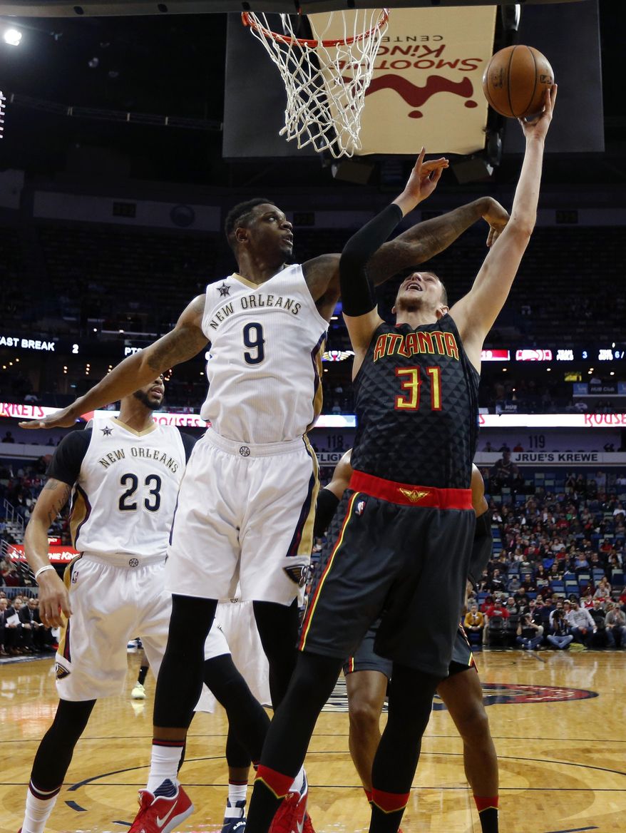 Atlanta Hawks forward Mike Muscala (31) goes to the basket against New Orleans Pelicans forward Terrence Jones (9) in the first half of an NBA basketball game in New Orleans, Thursday, Jan. 5, 2017. (AP Photo/Gerald Herbert)