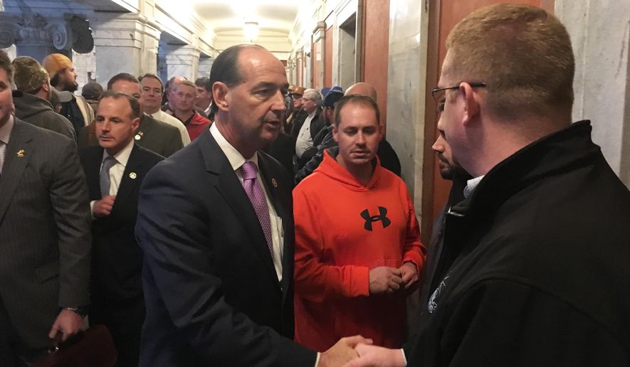 Democratic state Rep. Rocky Adkins greets union workers outside of the state House chamber on Thursday, Jan. 5, 2017, in Frankfort, Ky. House Republicans were scheduled to pass several bills targeting labor unions on the third day of the legislative session. (AP Photo/Adam Beam)