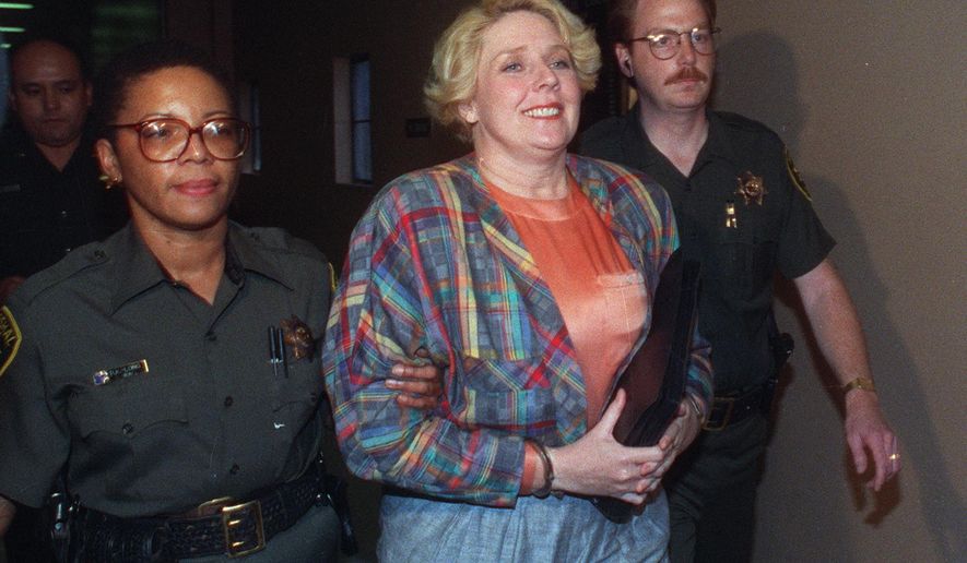 This Dec. 10, 1991 file photo shows Elisabeth "Betty" Broderick being led by marshals through the hallways of the downtown San Diego County Courthouse. Parole has been denied for Broderick, a San Diego socialite who killed her ex-husband and his new wife in 1989. Broderick faced a parole board on Wednesday, Jan. 4, 2017, at a women's prison in Corona, Calif., where she's serving 32 years to life. She was denied parole in 2010 by a panel that said she showed no remorse. (The San Diego Union-Tribune via AP, File)