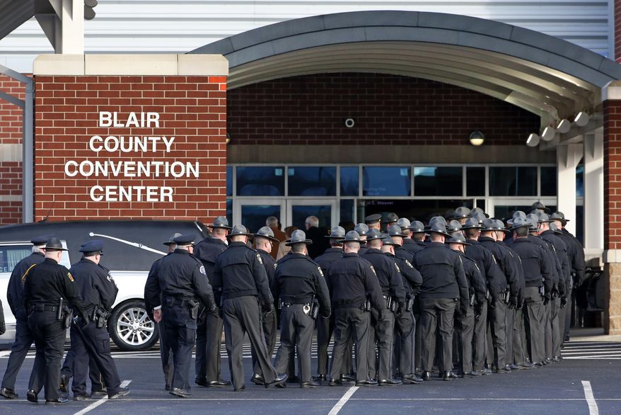 Pennsylvania State Troopers and police officers from around the country arrive at the Blair County Convention Center in Altoona, Pa., Thursday, Jan. 5, 2017, for a memorial service for Pennsylvania State Trooper Landon E. Weaver who was killed in the line of duty Dec. 30. Weaver, 23, had been on the force for less than six months. (AP Photo/Gene Puskar)