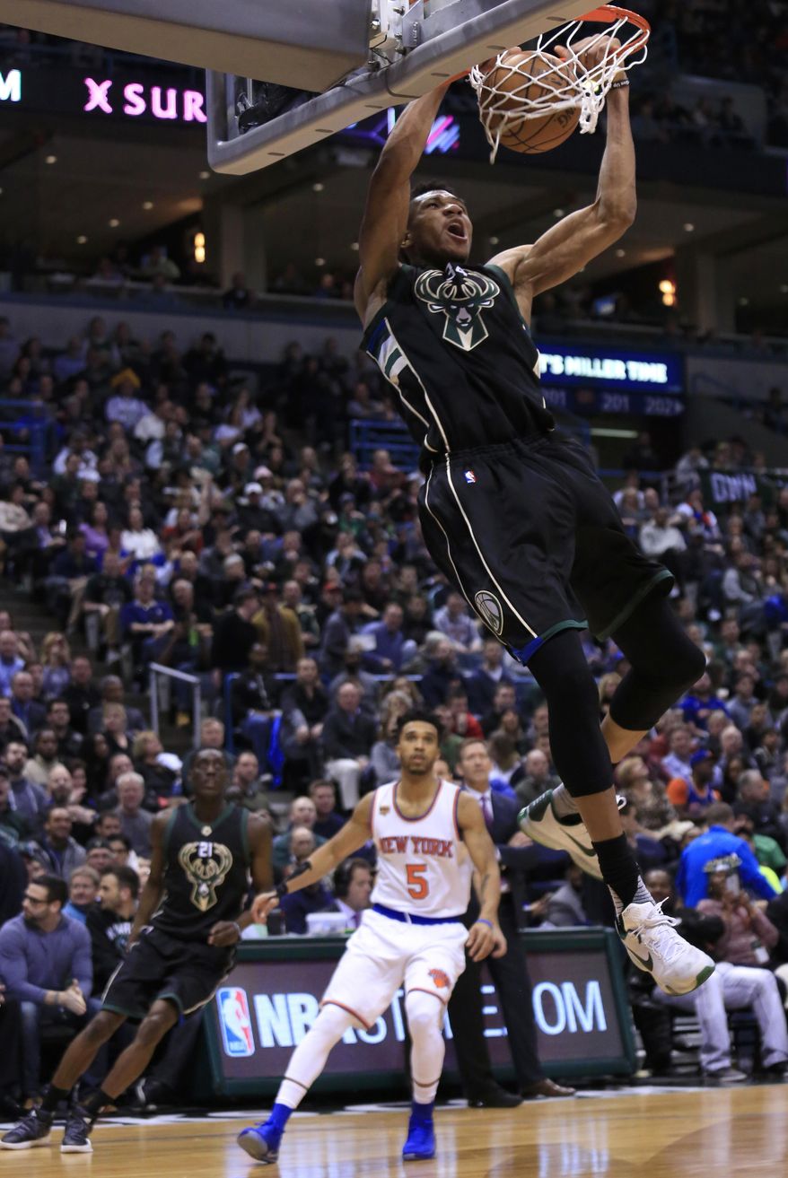 Milwaukee Bucks forward Giannis Antetokounmpo, top, slam-dunks against the New York Knicks during the second half of an NBA basketball game Friday, Jan. 6, 2017, in Milwaukee. (AP Photo/Darren Hauck)