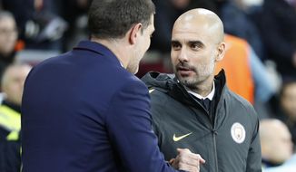West Ham&#x27;s manager Slaven Bilic, left, shakes hands with Manchester City&#x27;s manager Pep Guardiola ahead of the FA Cup third round soccer match between West Ham United and Manchester City at the London stadium in London, Friday, Jan. 6, 2017. (AP Photo/Kirsty Wigglesworth)