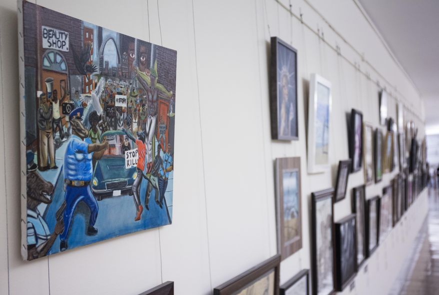 In this Jan. 5, 2017, photo, a painting by David Pulphus hangs in a hallway displaying paintings by high school students selected by their member of congress on Capitol Hill in Washington. Rep. Duncan Hunter, R-Calif., has removed a painting that showed a pig in a police uniform, one of hundreds of artworks on display at the Capitol and sponsored by a member of Congress. Joe Kasper, a spokesman forHunter, says the lawmaker unscrewed the artwork from the display and returned it to the office of Missouri Democratic Rep. William Lacy Clay. (AP Photo/Zach Gibson)