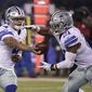 FILE - In this Sunday, Dec. 11, 2016 file photo, Dallas Cowboys quarterback Dak Prescott (4) hands the ball to Ezekiel Elliott (21) during the second half of an NFL football game against the New York Giants in East Rutherford, N.J. Ezekiel Elliott pelted fellow rookie Dak Prescott with straw wrappers and a spitball when the Dallas quarterback was surrounded by reporters, trying to explain how he kept the task of replacing Tony Romo from becoming too big. (AP Photo/Seth Wenig, File)
