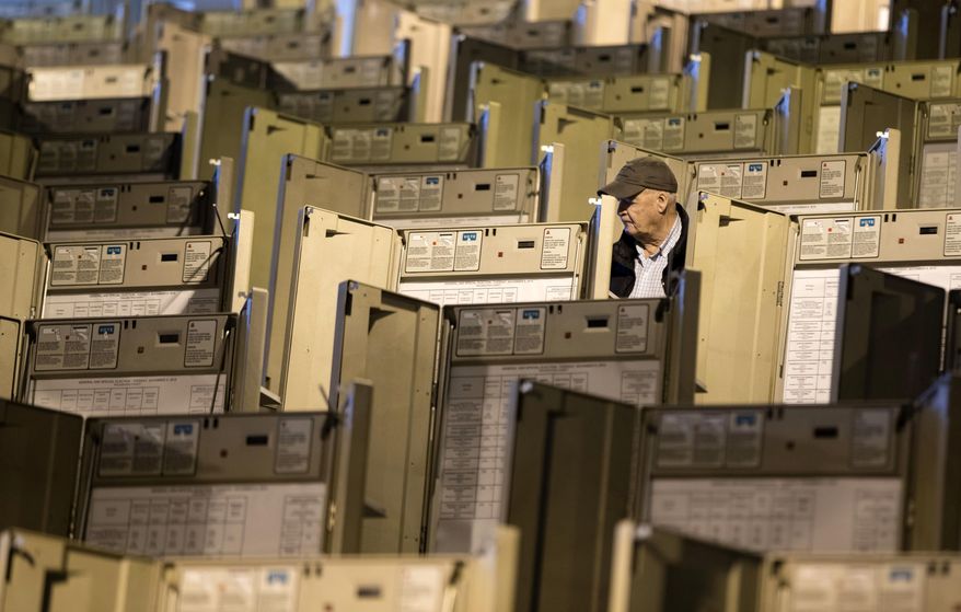 FILE - In this Oct. 14, 2016, file photo, a technician works to prepare voting machines to be used in the presidential election, in Philadelphia. Homeland Security Secretary Jeh Johnson has told state officials that he is moving toward designating U.S. election systems as critical infrastructure, a designation that will provide more federal help for states to keep election systems safe from tampering. (AP Photo/Matt Rourke, File)